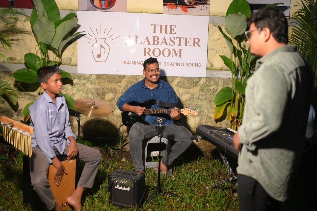Teacher coaching a young band outdoors